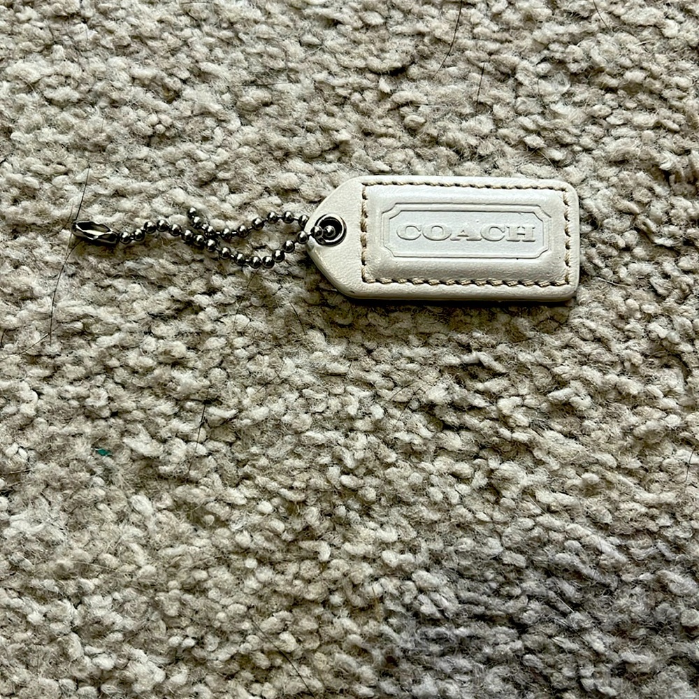 Coach Logo Leather Hang Tag Charm - cream colored.  
Silver Chain 2”. Like new!